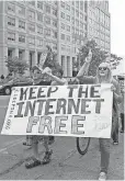  ?? KAREN BLEIER, AFP/ GETTY IMAGES ?? Demonstrat­ors outside the FCC on Monday.