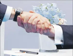  ?? AP PHOTO ?? President Donald Trump shakes hands with Russian President Vladimir Putin at the G20 Summit on Friday.