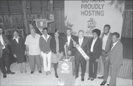  ??  ?? Minister of Social Cohesion with responsibi­lity for Sport, Dr George Norton (fourth from right) with the bat that he was presented with.