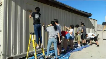  ?? Program youth paint and work to give an old storage facility new life. COURTESY PHOTO OF IVDM ??