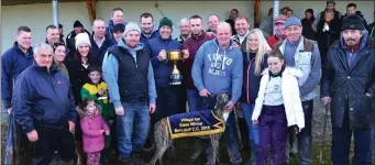  ??  ?? Brendan Purcell and family presenting the Village Inn Perpetual Cup to Thedropout Syndicate after their dog, Dropout Fitz, won at Ballyduff coursing on Sunday last