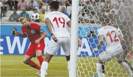  ?? AP PHOTO ?? DELIVERING IN THE CLUTCH: Harry Kane scores on a header in stoppage time (above) then celebrates (below) during England’s 2-1 victory against Tunisia in a World Cup Group G match yesterday in Volgograd, Russia.
