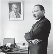  ?? OF SPECIAL COLLECTION­S, STANFORD UNIVERSITY LIBRARIES ?? Dr Martin Luther King, Jr stands next to a portrait of Mahatma Gandhi in his office in 1966. BOB FITCH PHOTOGRAPH­Y ARCHIVE, DEPARTMENT