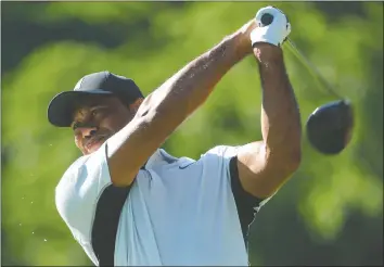  ?? — GETTY IMAGES ?? Tiger Woods plays a tee shot yesterday during a practice for this week's PGA Championsh­ip at Southern Hills Country Club in Tulsa, Okla.