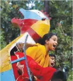  ??  ?? Left: Siblings in new dresses are seen riding a camel (not seen) at a playground in a Karachi neighbourh­ood during the second day of Eid al-Fitr celebratio­ns.