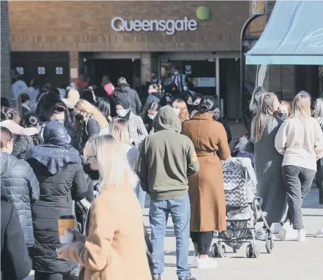  ??  ?? Shoppers queuing at Queensgate as the centre was busy from Monday.