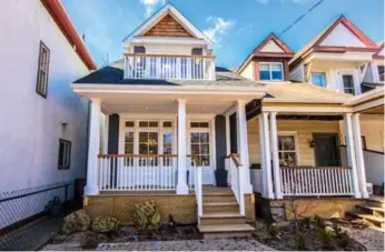  ?? KELLER WILLIAMS REFERRED URBAN REALTY PHOTOS ?? The exterior features a wood façade, cedar shingles, decorative pillars, a covered porch and a Juliette balcony.