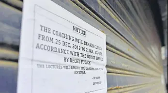 ?? SANCHIT KHANNA/HT PHOTO ?? A notice pasted outside a coaching institute in Delhi.