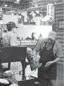  ?? Michael Ciaglo / Houston Chronicle ?? Classic Shoe Shine Company leather technician Norman Hardy can make between $200 and $600 per day during the course of the three-week Houston Livestock Show and Rodeo.