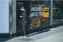  ?? (Dylan Martinez/Reuters) ?? A MAN uses an ATM in London yesterday.