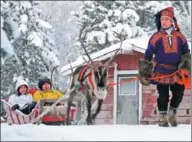  ?? ZHAO CHANGCHUN / XINHUA NEWS AGENCY ?? Chinese travelers take a reindeer sleigh in a tourist resort in Lapland, Finland.