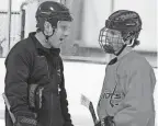  ?? FRANK DIRENNA/COLUMBUS DISPATCH ?? Olentangy Liberty interim coach Jonathon Falvo talks with Brady Long during practice Tuesday at Chiller North.