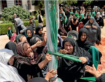  ?? ?? Shiite women in Kabul last week, marking part of Muharram, a month of mourning for Imam Hussein, grandson of the prophet Muhammad. Until the past two weeks, they were safe to gather outside, but a spate of terror attacks has led some community leaders to accuse the authoritie­s of ‘‘cancelling’’ the sacred rite instead of safeguardi­ng it.