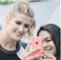  ?? THE CANADIAN PRESS ?? Eugenie Bouchard takes a selfie with a fan at a promo event.