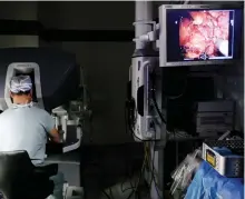  ?? M. SPENCER GREEN/AP ?? A surgeon performs robotic prostate surgery on a patient in Chicago.