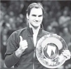  ?? - AFP photo ?? Switzerlan­d’s Roger Federer holds his trophy after winning the final match against Bulgary’s Grigor Dimitrov at the ABN AMRO World Tennis Tournament in Rotterdam.