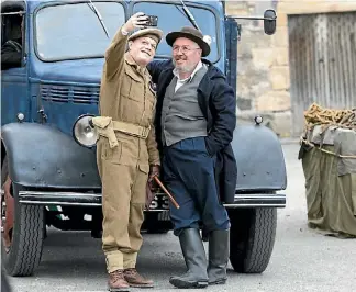  ??  ?? Izzard captures a quiet moment with Whisky Galore co-star Gregor Fisher.