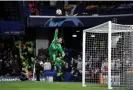  ?? Tony Obrien/Reuters ?? Real Madrid’s Thibaut Courtois makes a flying save at Stamford Bridge. Photograph: