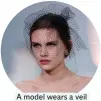  ??  ?? A model wears a veil for Chanel