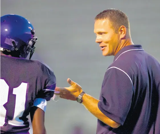  ?? GUY RHODES / POST-TRIBUNE ?? Zac Wells, right, was Merrillvil­le’s football coach for nine seasons before taking a job as the defensive coordinato­r at Homewood-Flossmoor in Illinois.