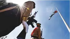  ?? Ahmed Ramzan/Gulf News ?? A flagraisin­g ceremony at Flag Island in Sharjah.