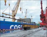  ?? PROVIDED TO CHINA DAILY ?? Steel rails are unloaded from a vehicle onto a ship at Fangchengg­ang Port, Guangxi Zhuang autonomous region.