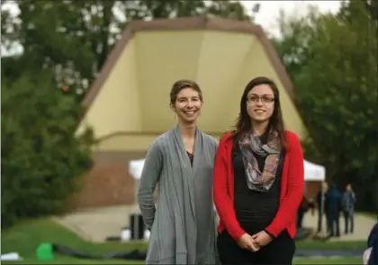  ?? DAVID BEBEE, RECORD STAFF ?? Jessica Larmer, left, and Emily van Riesen of the Waterloo Concert Band stand in front of the bandshell in Waterloo Park. The pair regularly perform there and are unsure about the future of the historic facility.