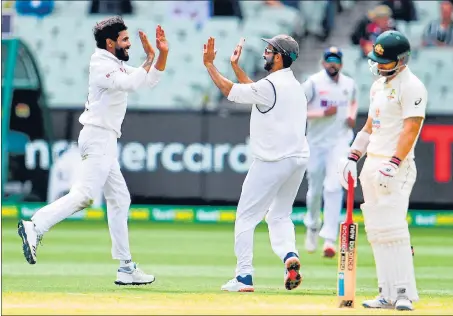  ?? AFP ?? India’s Ravindra Jadeja (L) and Ajinkya Rahane (C) celebrate dismissing Australia's Matthew Wade on the third day of the second Test in Melbourne.