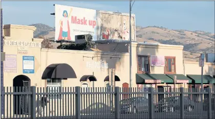  ?? RANDY VAZQUEZ — STAFF ARCHIVES ?? A billboard prompting the use of face mask sits atop a store on North White Road in San Jose in December 2020.