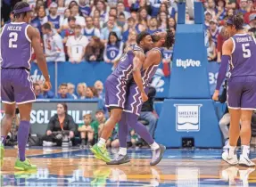  ?? WILLIAM PURNELL/USA TODAY SPORTS ?? Guard Mike Miles Jr., right, hugs guard Shahada Wells during TCU’s upset of Kansas.