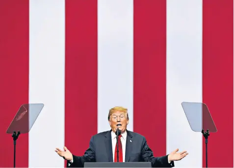  ??  ?? President Donald Trump looks like he doesn’t have a care in the world as he speaks at a rally in North Dakota before a tough round of talks with Russia next month