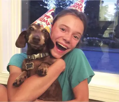  ?? PROVIDED ?? Peyton Crest with her dog at home in Minnetonka, Minnesota. The 18-year-old says she developed anorexia before the pandemic but has relapsed twice since it began.