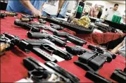  ?? SPENCER PLATT / GETTY IMAGES ?? Guns stand for sale at a gun show in November in Naples, Florida. Suicides and homicides involving guns have been increasing in the United States, according to a recent report.