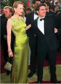  ?? Associated Press ?? ■ Tom Cruise and Nicole Kidman arrive for the 1997 Academy Awards. Kidman wore a Dior dress by John Galliano.