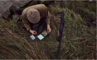  ?? ?? Once he is in position, Jack loads up his cartridge box and readies himself for the evening flight