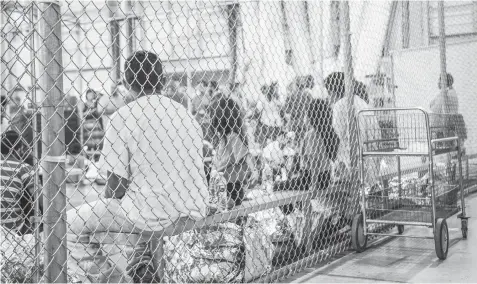  ?? AGENCE FRANCE PRESSE ?? In this file photo provided by US Customs and Border Protection, people who've been taken into custody related to cases of illegal entry into the United States, sit in one of the cages at a facility in McAllen, Texas.