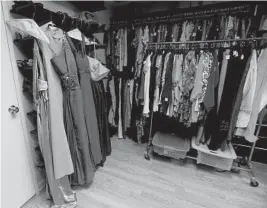  ?? PHOTOS BY MARIA LORENZINO/STAFF PHOTOGRAPH­ER ?? Prom dresses hang on a rack at Cool Clothes Closet. They are donated by residents.