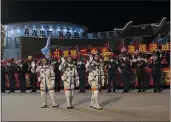  ?? YOU LI — THE NEW YORK TIMES ?? Chinese astronauts wave to a crowd before boarding the Shenzhou 15 spacecraft at Jiuquan Satellite Launch Center, deep in the Gobi Desert of China, on their way to the country’s Tiangong space station, Nov. 29.