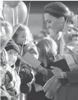  ??  ?? The Duchess of Cambridge talks with children at a youth arts festival in Whitehorse on Wednesday.