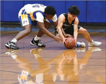  ?? PHOTOS BY CHRIS RILEY — TIMES-HERALD ?? Benicia High’s Miles Bailey fights for the ball with American Canyon’s E.J. Alviz during the Panthers’ 71-58loss to the Wolves on Thursday.