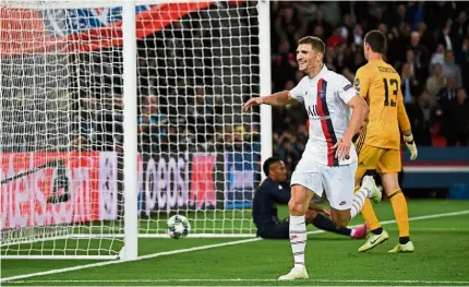  ??  ?? Nail in the coffin: Paris St Germain’s Thomas Meunier (in white) celebratin­g after scoring his side’s third goal in the Champions League Group A match against Real Madrid at the Parc des Princes on Wednesday. — AFP