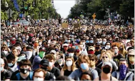  ?? ALEX BRANDON / ASSOCIATED PRESS ?? Demonstrat­ors in Washington, D.C., pause to kneel as they march to protest the death of George Floyd on Tuesday. Floyd died on Memorial Day after being restrained by Minneapoli­s police officers.