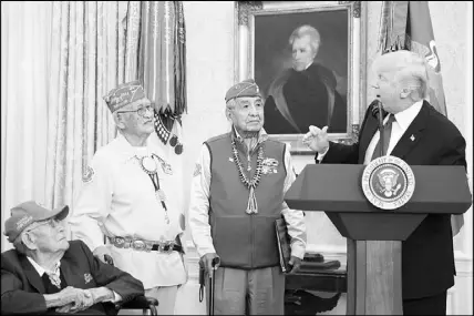  ?? TOM BRENNER / THE NEW YORK TIMES ?? President Donald Trump delivers remarks alongside Navajo code talkers during a Nov. 27, 2017, event at the White House. Trump used the event honoring Navajo veterans of World War II to utter a favorite Native American-related insult of a political opponent, deriding Sen. Elizabeth Warren, D-Mass., as “Pocahontas.”