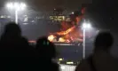  ?? Photograph: Jiji Press/EPA ?? People on a viewing platform as the plane burst into flames.