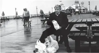  ??  ?? Pier pleasure: eating fish and chips at Eastbourne, as captured by Don Mccullin (2018)
