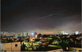  ?? HASSAN AMMAR/AP PHOTO ?? Explosions light up the sky with anti-aircraft fire over Damascus, the Syrian capital, early today as the U.S. launches an attack on Syria targeting different parts of Damascus in retaliatio­n for the country’s alleged use of chemical weapons.