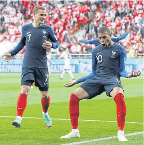  ??  ?? France’s Kylian Mbappe, right, reacts after scoring against Peru.