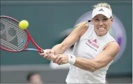  ?? KIRSTY WIGGLESWOR­TH – THE ASSOCIATED PRESS ?? Three-time Grand Slam champion Angelique Kerber, above, defeated Karolina Muchova 6-2, 6-3 in Tuesday’s quarterfin­al match at the Wimbledon Tennis Championsh­ips.