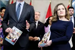  ?? CP PHOTO JUSTIN TANG ?? Prime Minister Justin Trudeau and Minister of Finance Chrystia Freeland hold copies of the federal budget as they pose for a photo before its tabling on Tuesday.