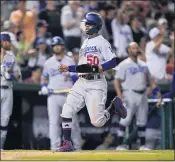  ??  ?? The Dodgers’ Mookie Betts scores on a single by Max Muncy during the seventh inning of L.A.’s victory.